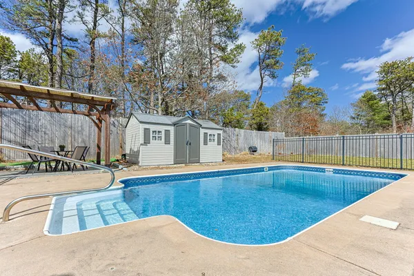 swimming pool view with sitting space and garden view