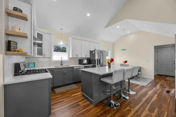 a kitchen that has a table and chairs in it
