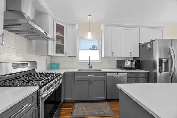 a kitchen with a sink stove and refrigerator