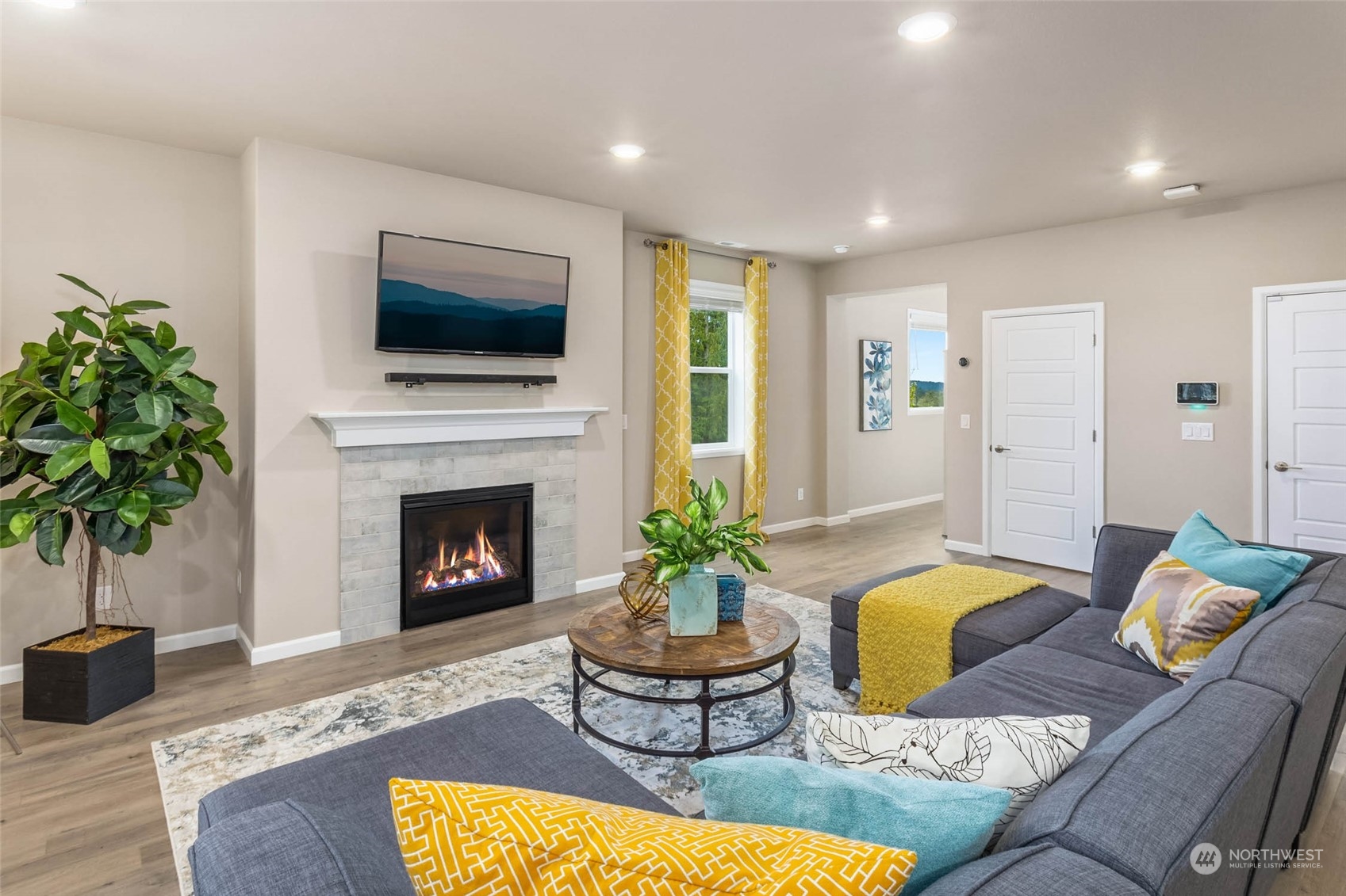 217 178th Street Southeast Bothell, WA 98012 - Photo 13 of 37 a living room with furniture a flat screen tv and a fireplace