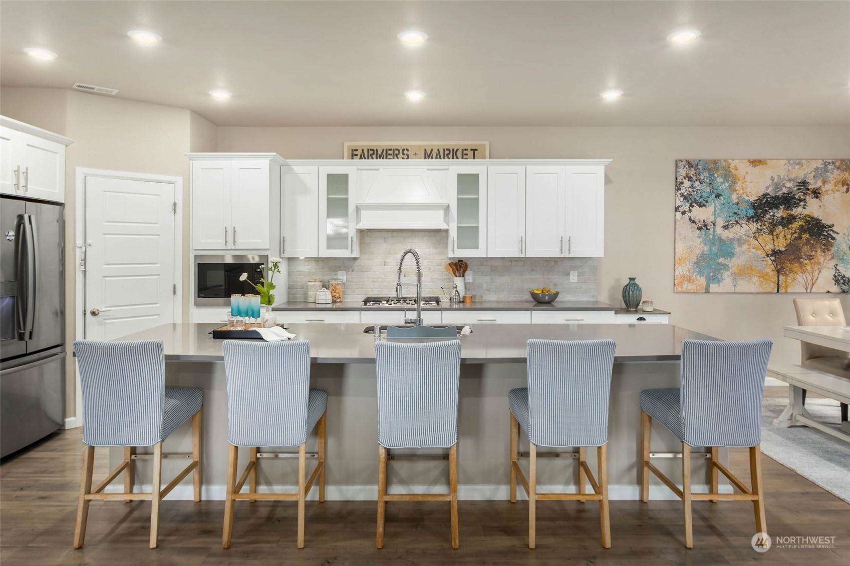 217 178th Street Southeast Bothell, WA 98012 - Photo 6 of 37 a kitchen with a dining table chairs refrigerator and cabinets
