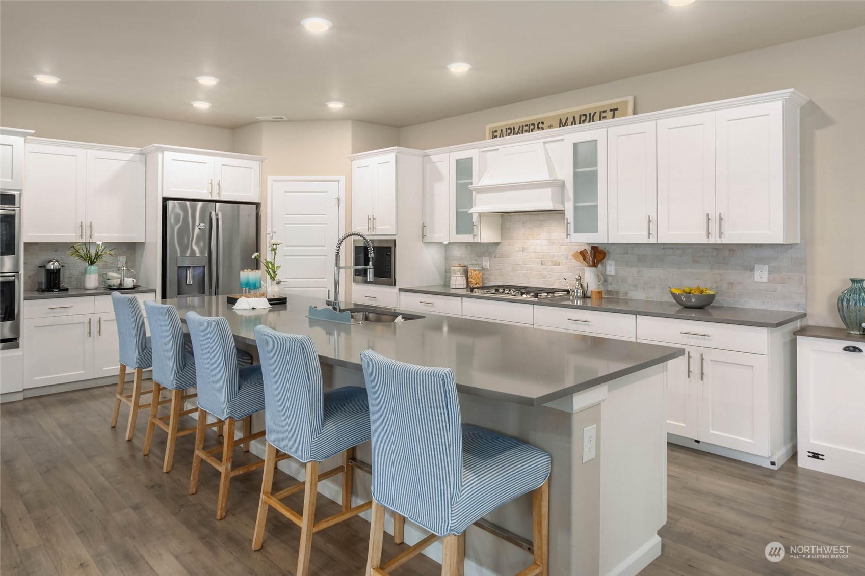 217 178th Street Southeast Bothell, WA 98012 - Photo 7 of 37 a kitchen with stainless steel appliances granite countertop a table chairs sink refrigerator and cabinets