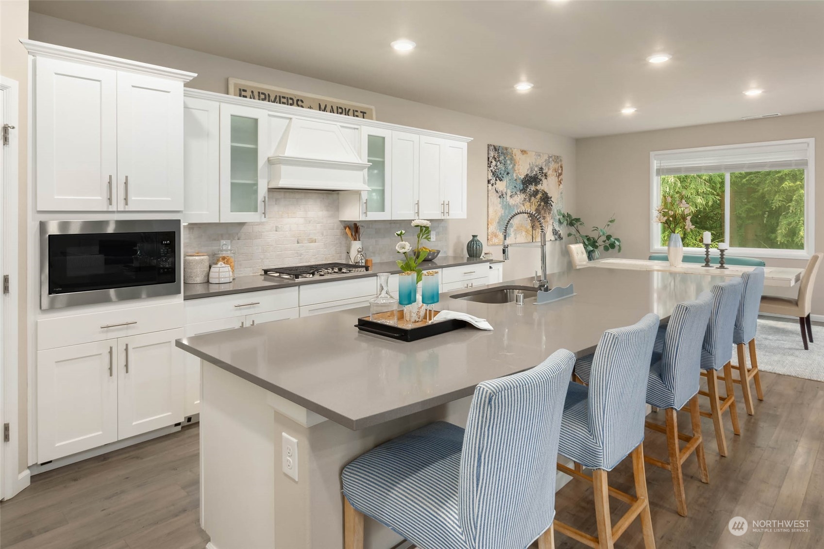 217 178th Street Southeast Bothell, WA 98012 - Photo 8 of 37 a kitchen with stainless steel appliances a kitchen island hardwood floor sink stove and white cabinets