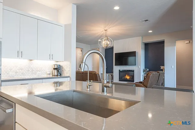 a kitchen with stainless steel appliances granite countertop a sink a counter space and cabinets