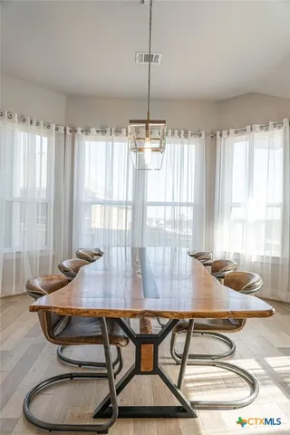 a dining room with furniture and window