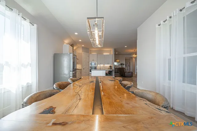 a swimming pool with a large window and chandelier