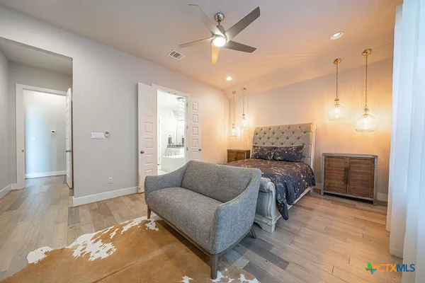 a living room with a couch and a ceiling fan