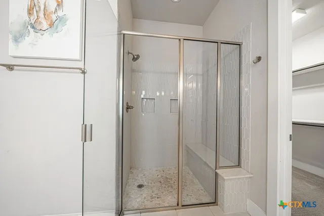a bathroom with a glass shower door