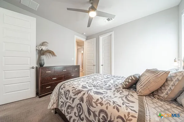 a bedroom with a bed and a painting on the wall