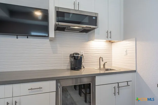 a kitchen with a sink and cabinets