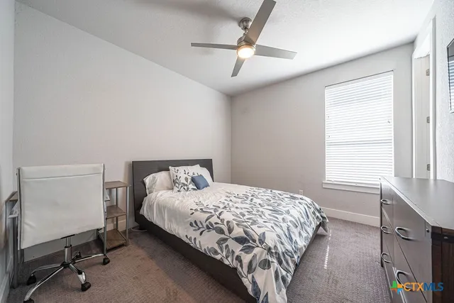 a bedroom with a bed and a desk in it