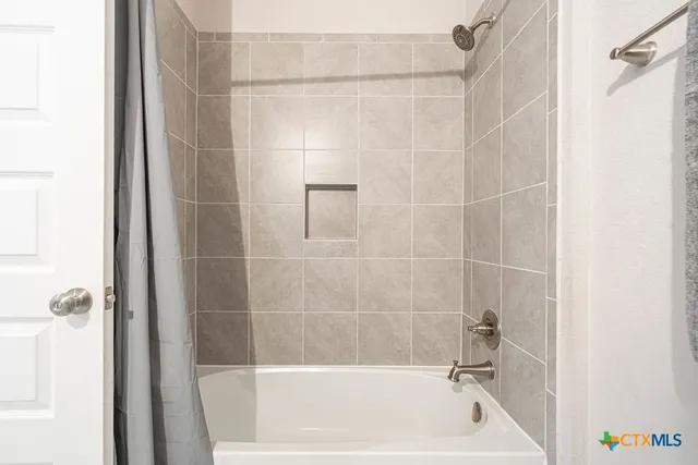 a bath tub sitting next to a white sink