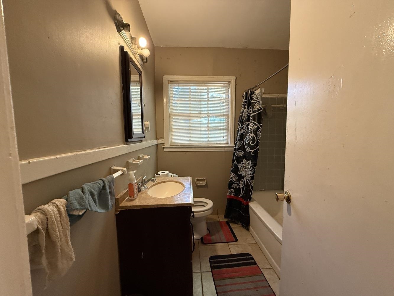 1309 Semmes Street Memphis, TN 38111 - Photo 16 of 24 Full bath featuring vanity, shower / bath combination with curtain, and light tile patterned flooring