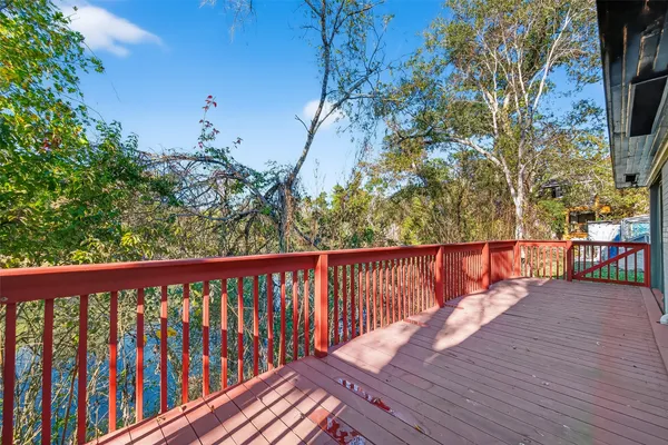 a balcony with wooden floor and fence