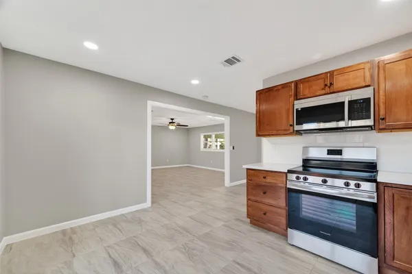a kitchen with stainless steel appliances a stove and a microwave