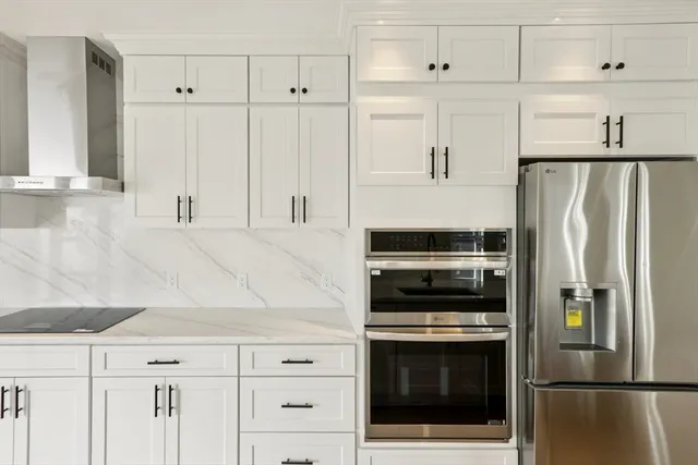 a kitchen with cabinets and stainless steel appliances