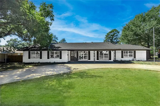 a view of a house with a yard and roof
