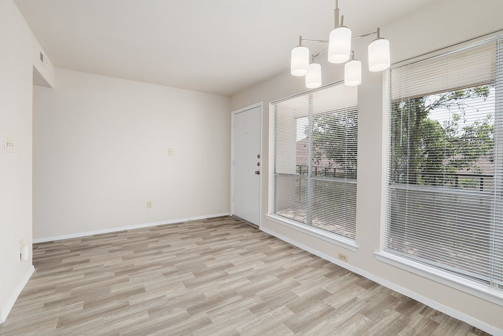 6910 Hart Lane, Unit 907 Austin, TX 78731 - Photo 12 of 28 a view of a livingroom with a chandelier fan and hardwood floor