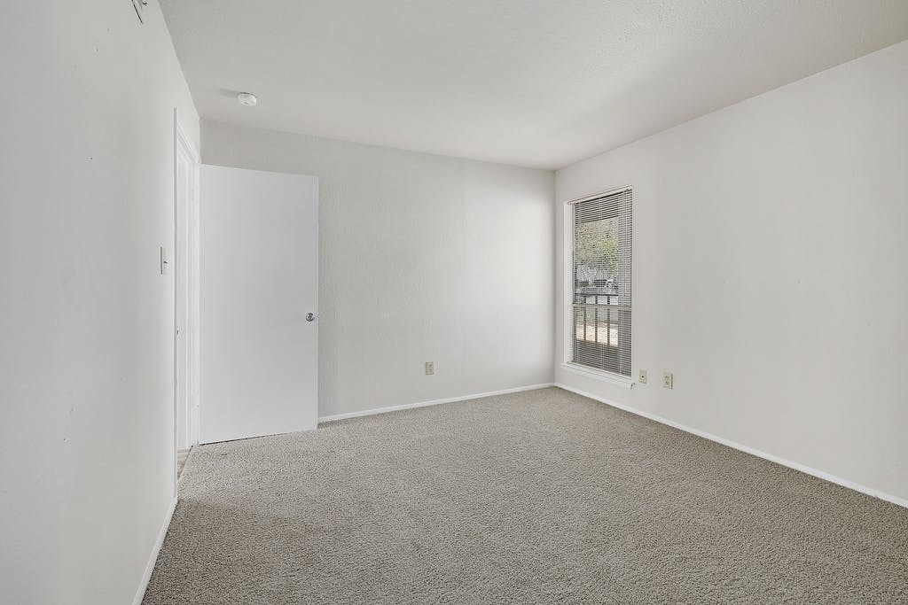 6910 Hart Lane, Unit 907 Austin, TX 78731 - Photo 17 of 28 a view of an empty room with a window