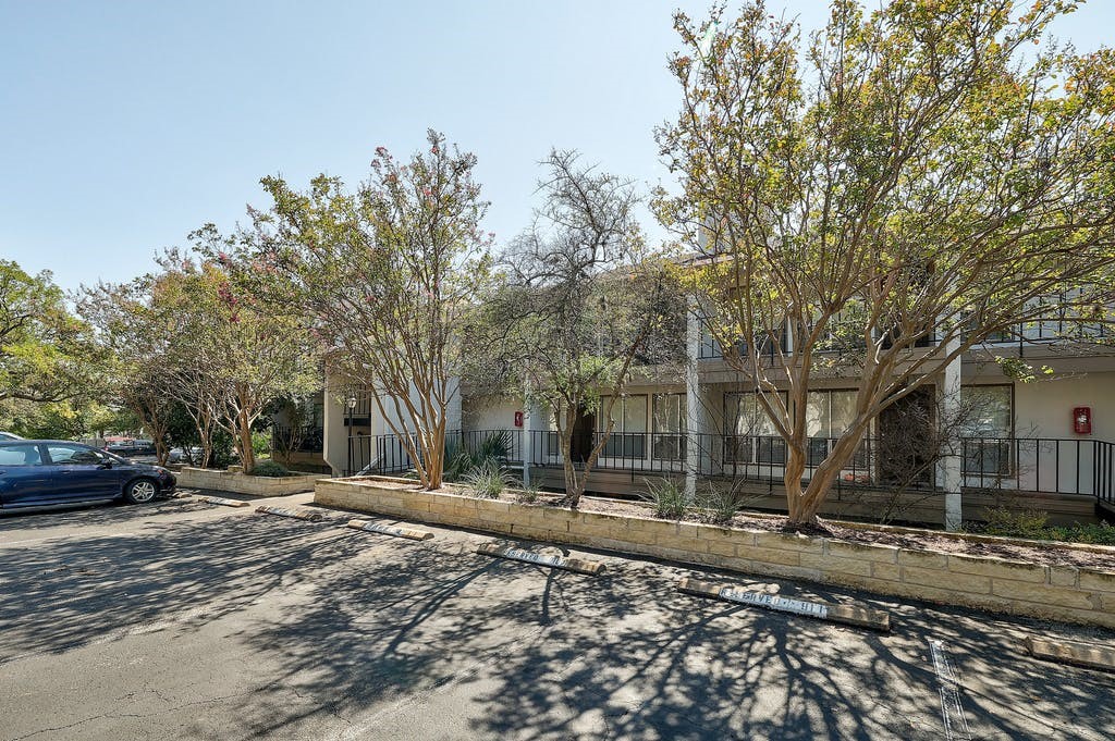 6910 Hart Lane, Unit 907 Austin, TX 78731 - Photo 2 of 28 a backyard of a house with trees