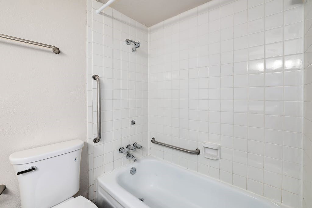 6910 Hart Lane, Unit 907 Austin, TX 78731 - Photo 24 of 28 a bathroom with a tub and a shower
