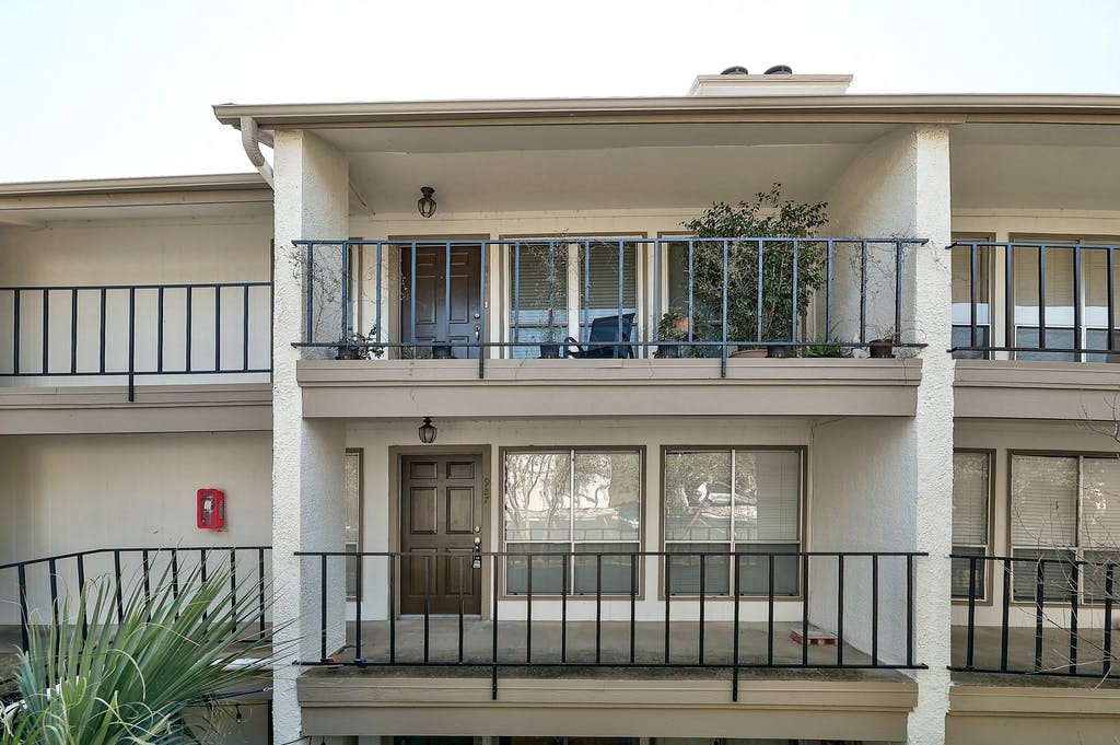6910 Hart Lane, Unit 907 Austin, TX 78731 - Photo 3 of 28 a front view of a house with a porch