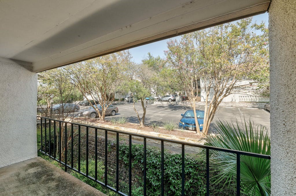 6910 Hart Lane, Unit 907 Austin, TX 78731 - Photo 5 of 28 a view of trees and deck in the balcony