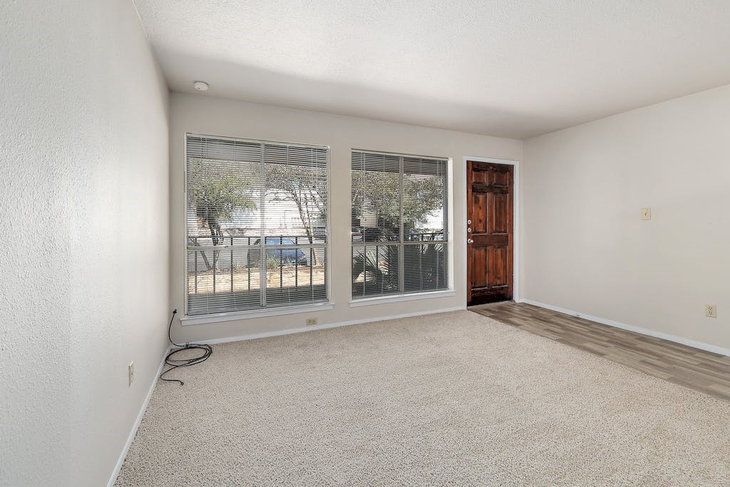 6910 Hart Lane, Unit 907 Austin, TX 78731 - Photo 6 of 28 an empty room with windows