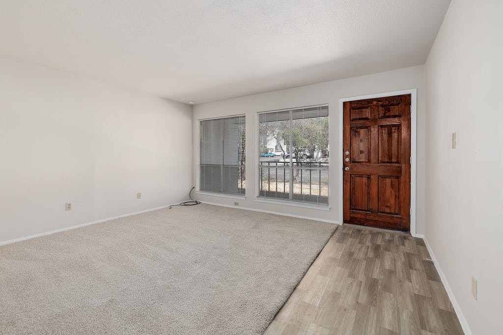 6910 Hart Lane, Unit 907 Austin, TX 78731 - Photo 7 of 28 an empty room with windows