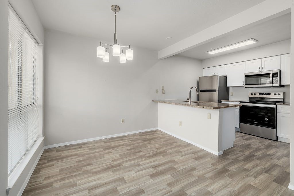 6910 Hart Lane, Unit 907 Austin, TX 78731 - Photo 10 of 28 a kitchen with a sink chandelier and refrigerator