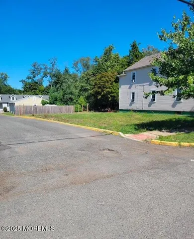 a view of a house with a yard and a garage