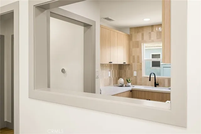 a kitchen with stainless steel appliances a stove and white cabinets