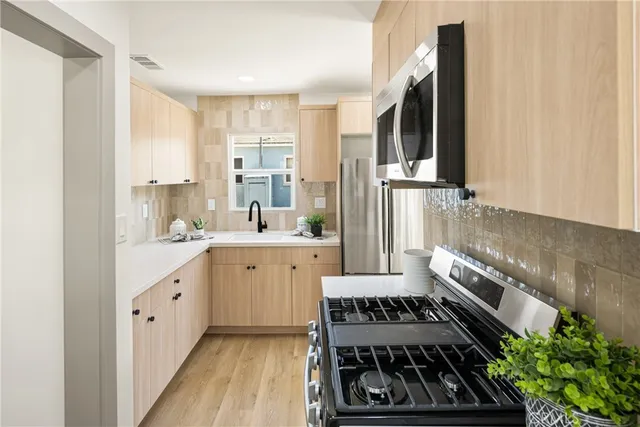 a kitchen with a sink stove and cabinets