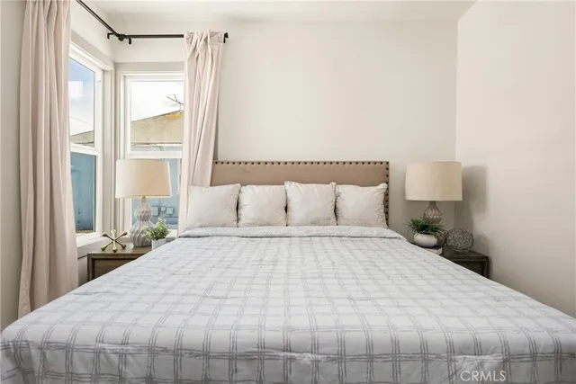 a view of an empty walk in closet and wooden floor