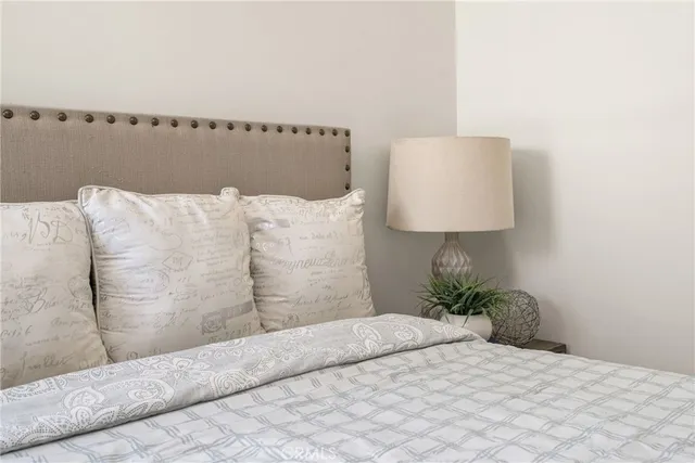 a large bed sitting in a bedroom next to a window