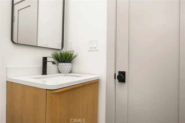 a white couch sitting on top of a table and a potted plant