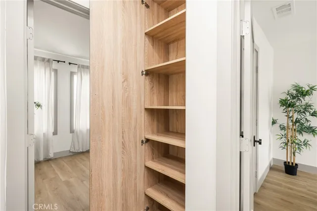 a dining room with furniture a floor to ceiling window and wooden floor