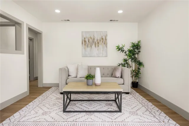 a bedroom with a large bed and a potted plant