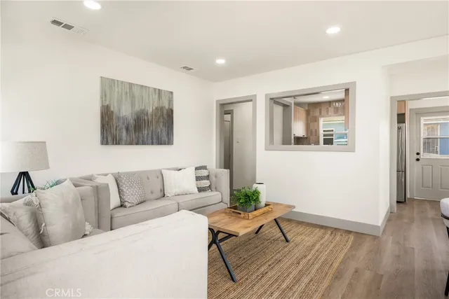 a living room with furniture and a potted plant