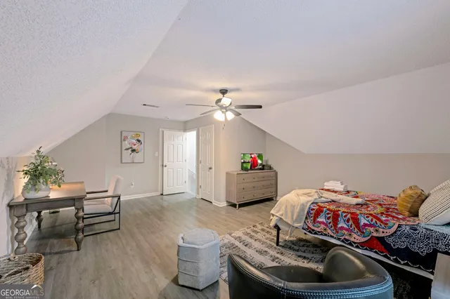 a very nice looking bedroom with a bed and a dresser