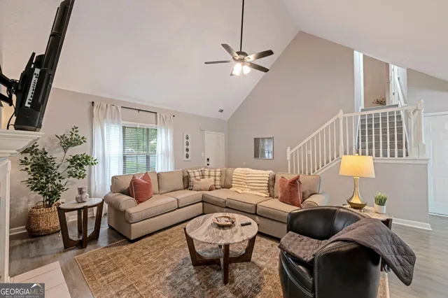 a living room with furniture and a potted plant