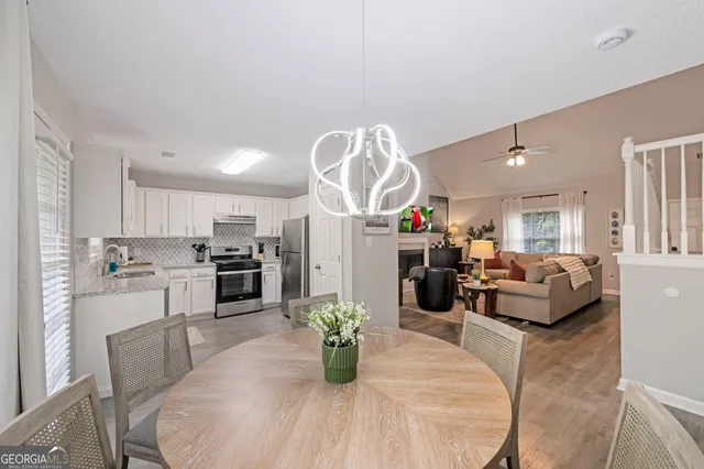 a dining room with furniture and wooden floor