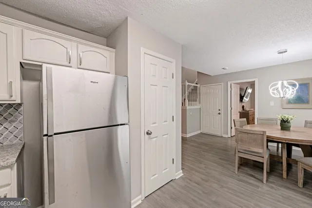 a kitchen with granite countertop a sink cabinets and dining table