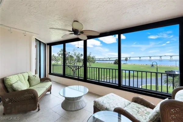 a living room with furniture and a floor to ceiling window