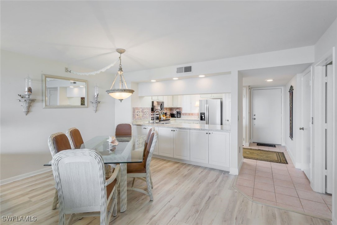 15010 Punta Rassa Road, Unit 108 Fort Myers, FL 33908 - Photo 11 of 30 a dining room with furniture and wooden floor