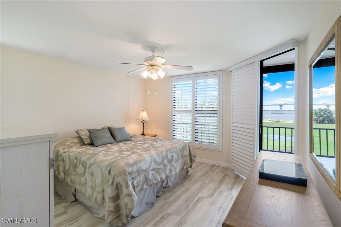 15010 Punta Rassa Road, Unit 108 Fort Myers, FL 33908 - Photo 14 of 30 a bedroom with a large bed and a chandelier