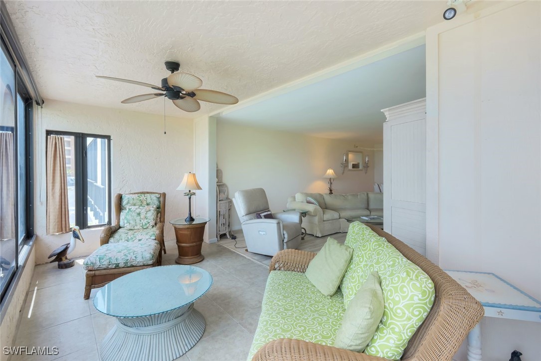 15010 Punta Rassa Road, Unit 108 Fort Myers, FL 33908 - Photo 20 of 30 a living room with furniture and a chandelier