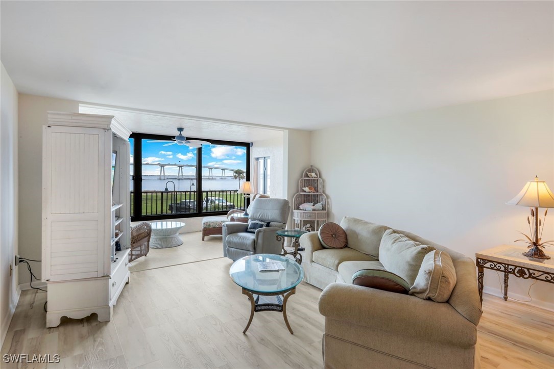 15010 Punta Rassa Road, Unit 108 Fort Myers, FL 33908 - Photo 5 of 30 a living room with furniture and a large window