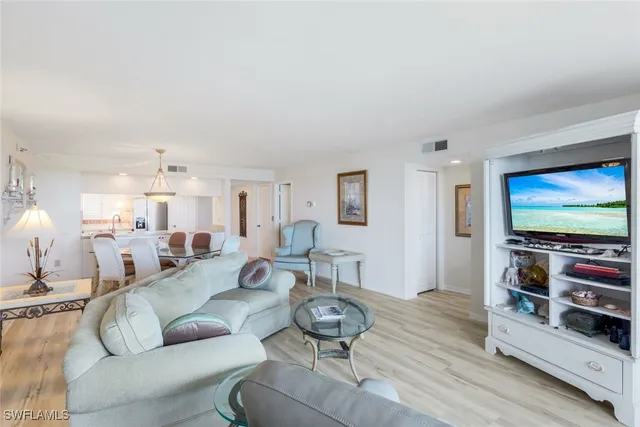 a kitchen with granite countertop a sink stainless steel appliances and white cabinets