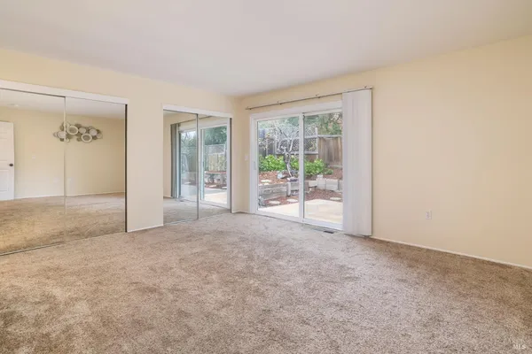 a bathroom with a granite countertop sink a mirror and a shower